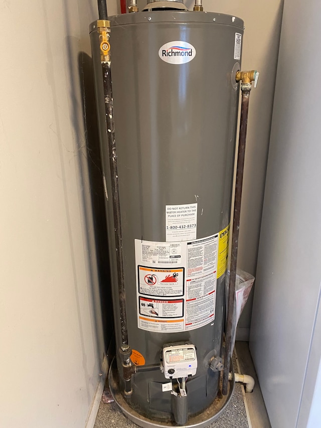 utility room featuring water heater