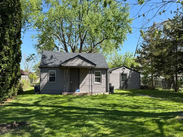 1095 Harding Dr, Grand Blanc, MI 48507 - back of property with a shingled roof, cooling unit, and an outdoor structure