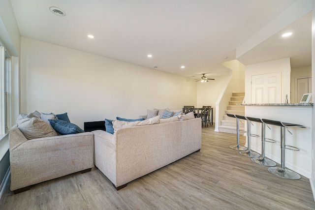 living room featuring ceiling fan and light wood-type flooring