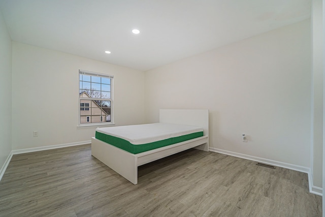 unfurnished bedroom with wood-type flooring