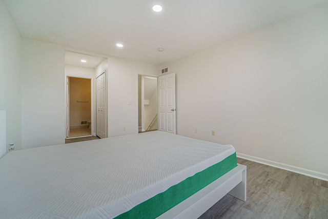 unfurnished bedroom with hardwood / wood-style flooring