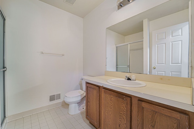 bathroom featuring tile patterned flooring, vanity, toilet, and an enclosed shower