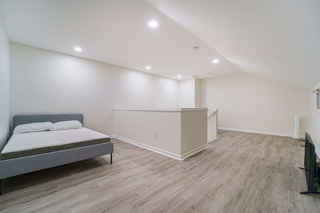 sitting room featuring lofted ceiling and light wood-type flooring