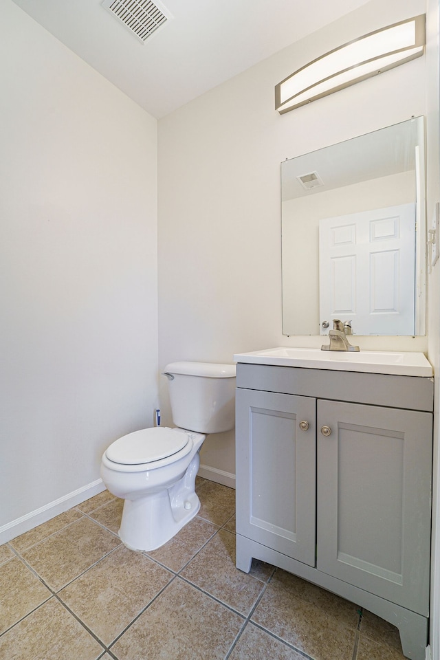 bathroom with vanity, tile patterned floors, and toilet