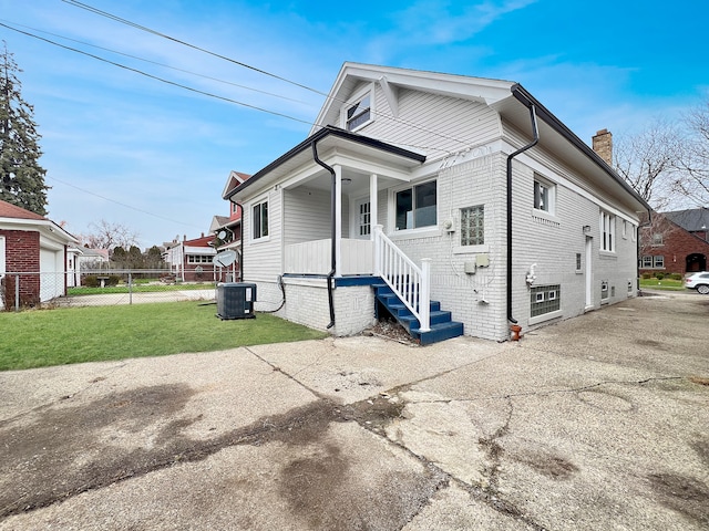 exterior space featuring a yard and central AC unit