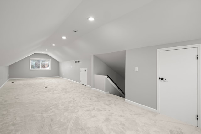 bonus room featuring vaulted ceiling and light carpet