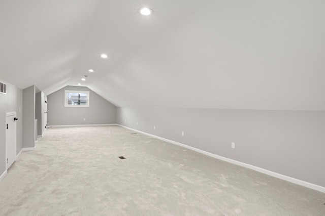 bonus room featuring light colored carpet and vaulted ceiling