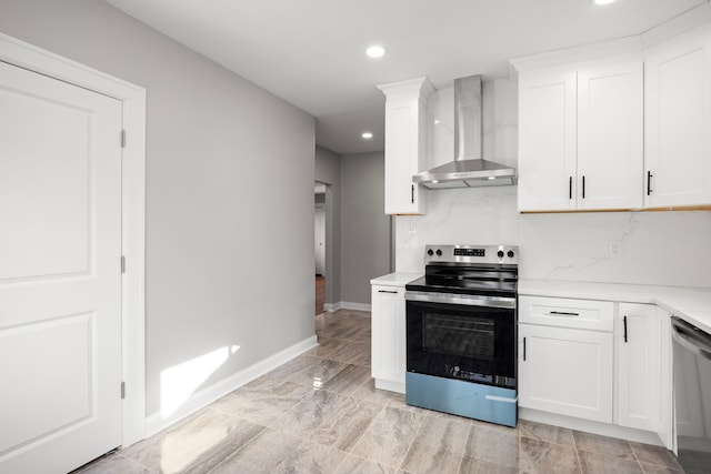 kitchen featuring white cabinets, backsplash, stainless steel appliances, and wall chimney exhaust hood