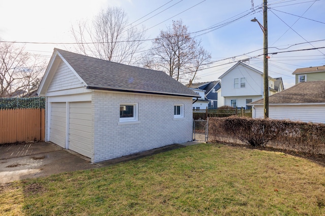 view of outbuilding with a garage and a lawn