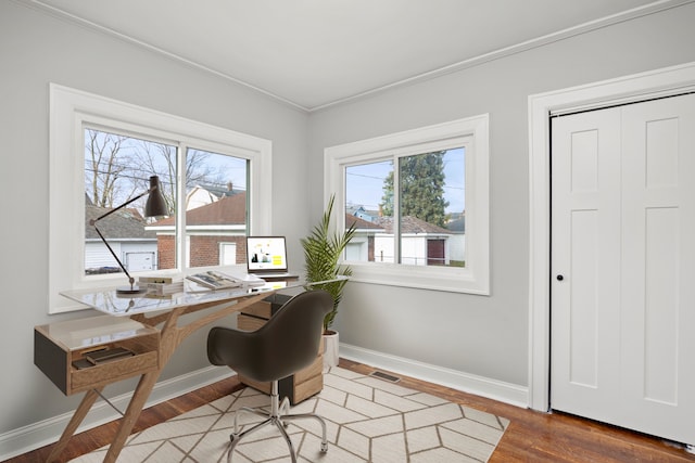 home office with crown molding and wood-type flooring