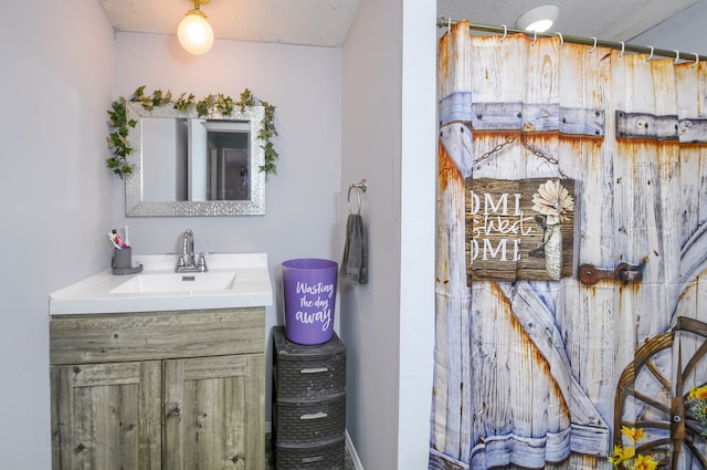 bathroom with vanity and a textured ceiling