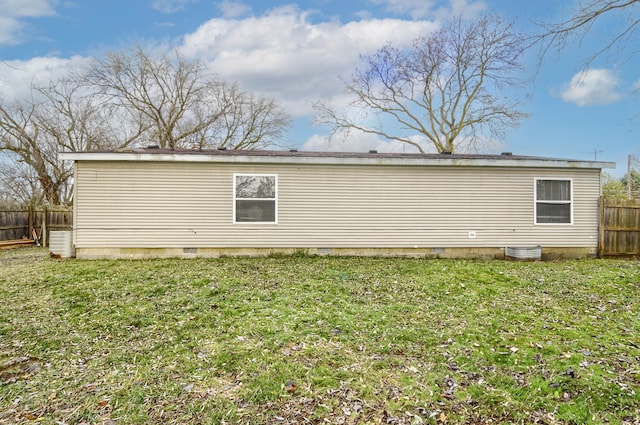 view of side of home featuring a yard