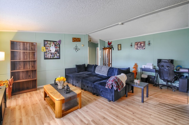 living room with vaulted ceiling, crown molding, light hardwood / wood-style flooring, and a textured ceiling