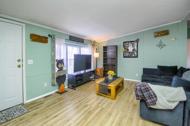 living room with a textured ceiling, lofted ceiling, light wood-type flooring, and crown molding