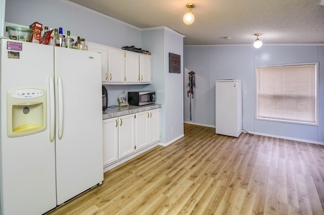 kitchen with white cabinetry, white fridge with ice dispenser, light hardwood / wood-style flooring, white fridge, and a textured ceiling