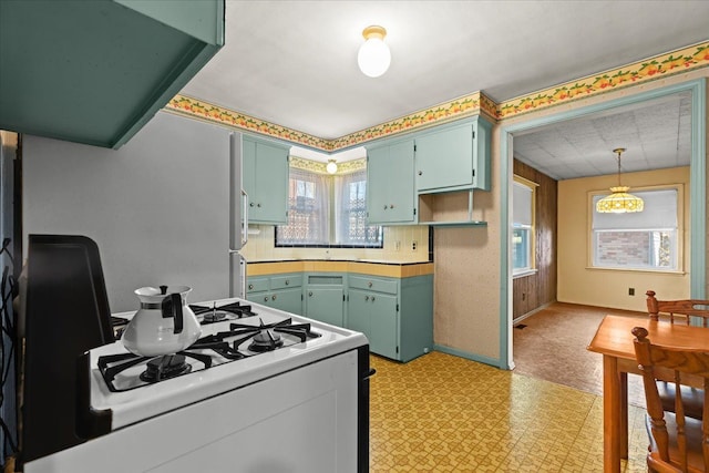 kitchen with wooden walls and gas range gas stove