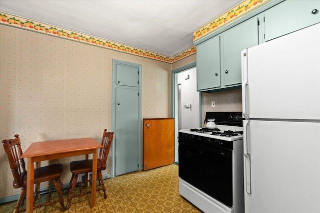 kitchen featuring white fridge and range with gas cooktop