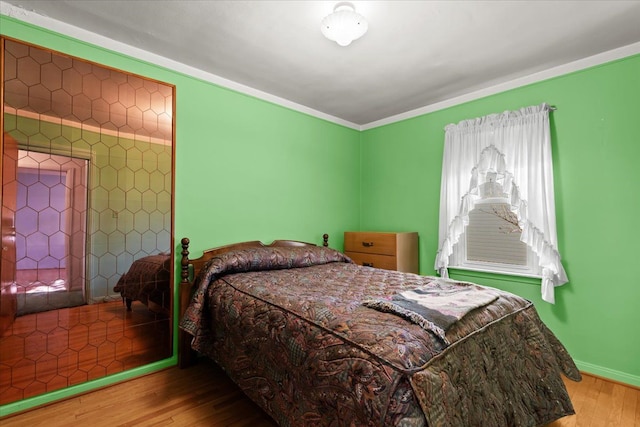 bedroom with hardwood / wood-style flooring