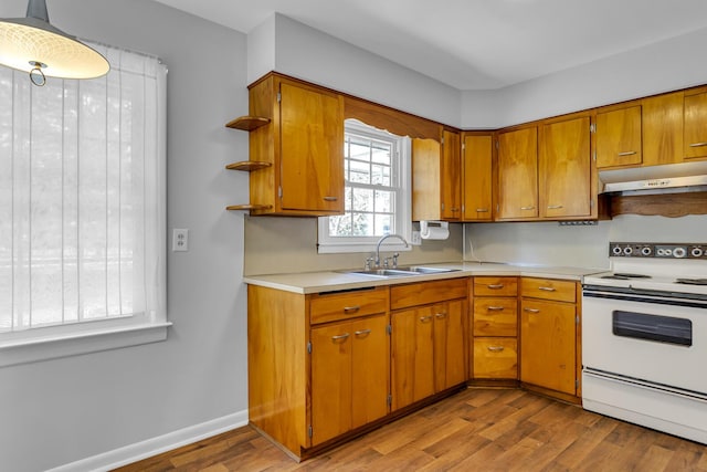 kitchen with pendant lighting, sink, light hardwood / wood-style floors, and white electric range