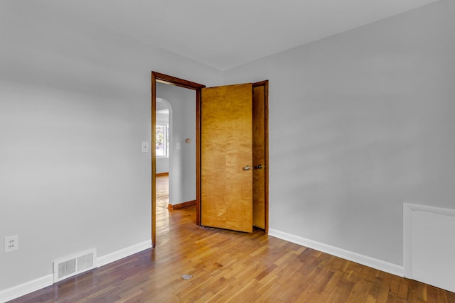 spare room featuring wood-type flooring