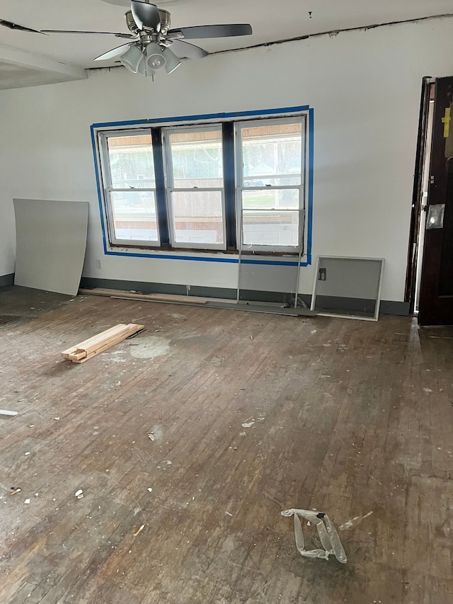 unfurnished room featuring ceiling fan and dark hardwood / wood-style flooring