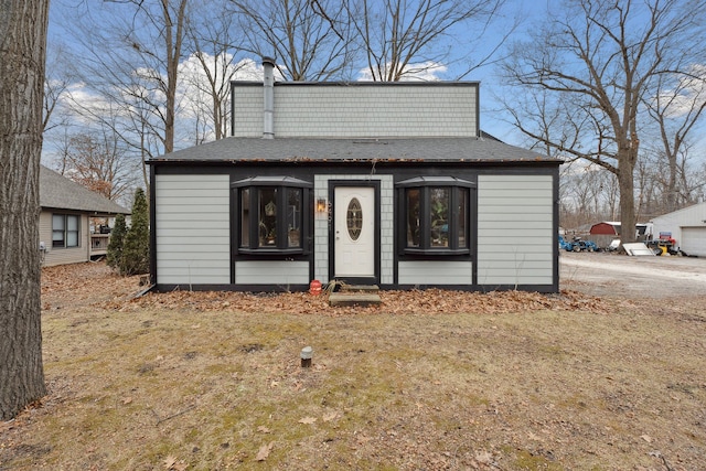 view of outbuilding featuring a lawn