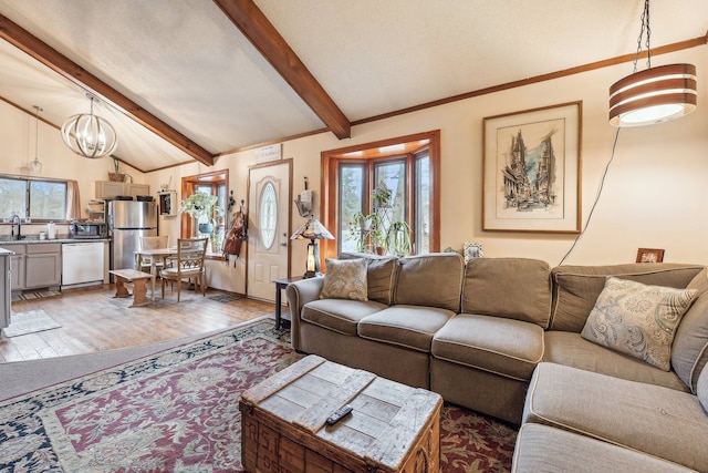 living room featuring dark hardwood / wood-style flooring, an inviting chandelier, lofted ceiling with beams, and sink