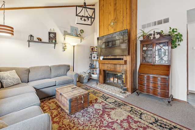 carpeted living room featuring an inviting chandelier