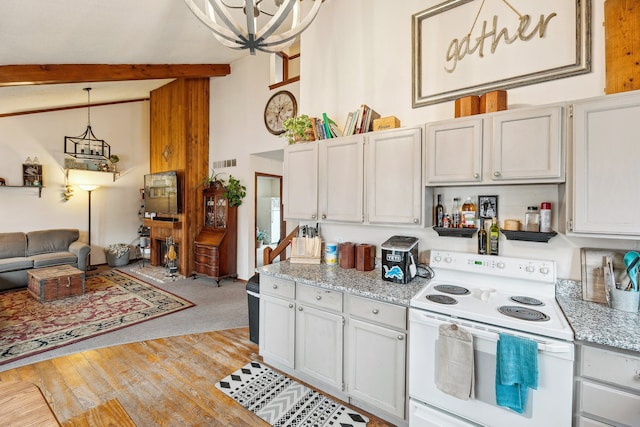 kitchen featuring light colored carpet, white cabinets, a chandelier, white range with electric cooktop, and hanging light fixtures