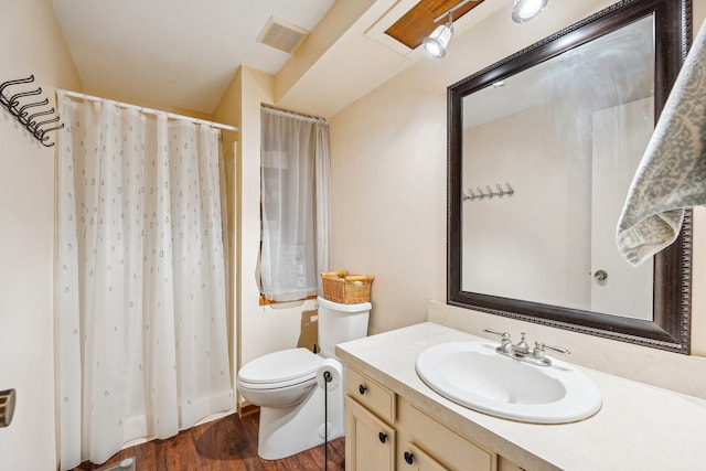 bathroom featuring vanity, toilet, and wood-type flooring