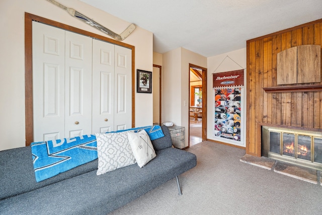 carpeted living room featuring wooden walls