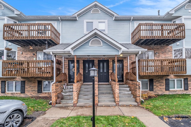 multi unit property with covered porch and a balcony