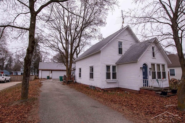 view of front facade featuring an outbuilding and a garage