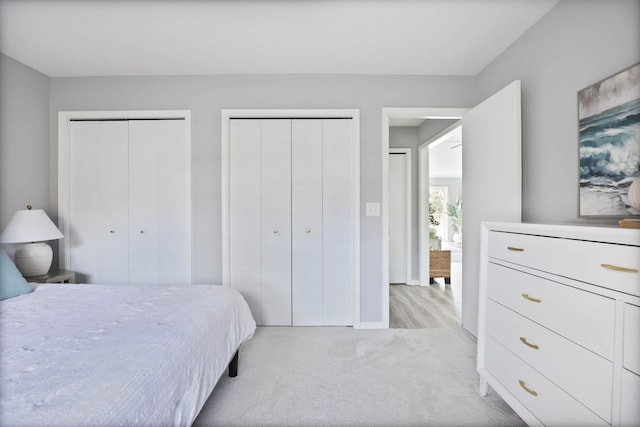 carpeted bedroom with multiple closets