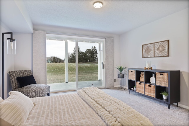 bedroom featuring access to exterior, a textured ceiling, and carpet flooring