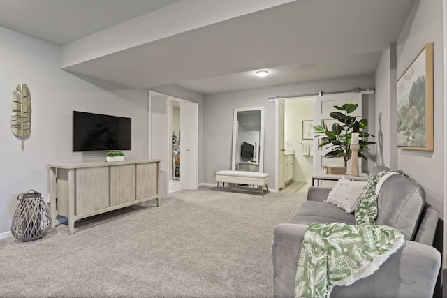 living room featuring a barn door and light colored carpet