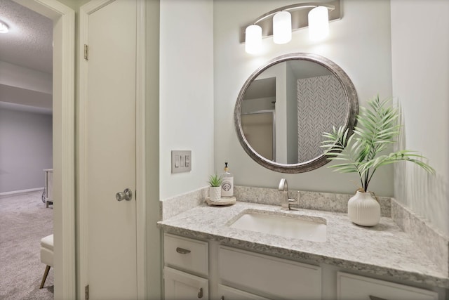 bathroom with a textured ceiling and vanity