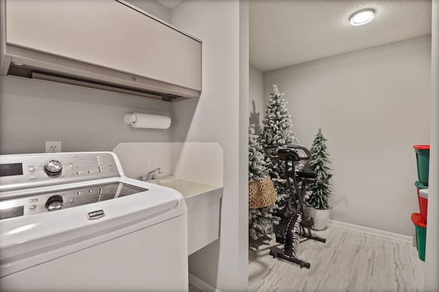 washroom featuring a textured ceiling and washer / clothes dryer