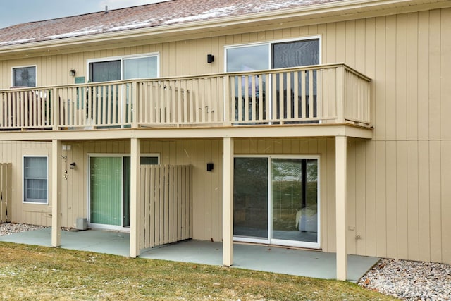 rear view of property featuring a patio and a balcony