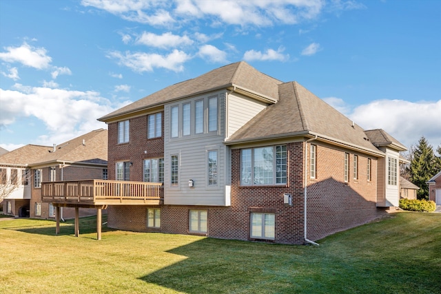 rear view of property with a lawn and a wooden deck