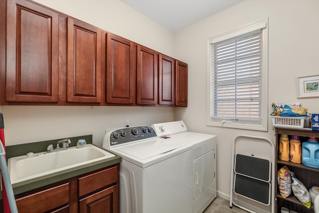 washroom featuring cabinets, washer and dryer, a healthy amount of sunlight, and sink