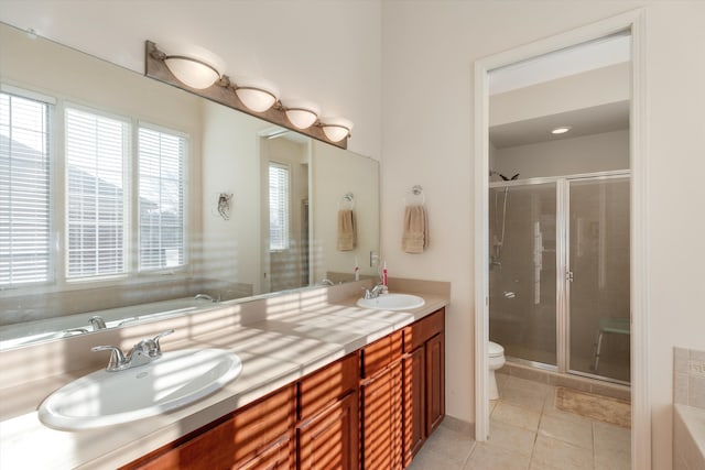 full bathroom with plus walk in shower, vanity, tile patterned floors, and toilet