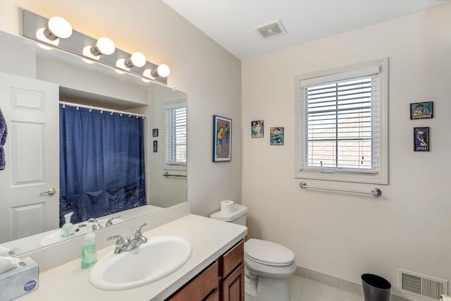 bathroom featuring tile patterned floors, vanity, and toilet