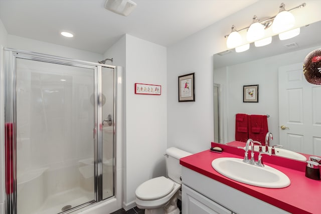 bathroom with vanity, an enclosed shower, and toilet