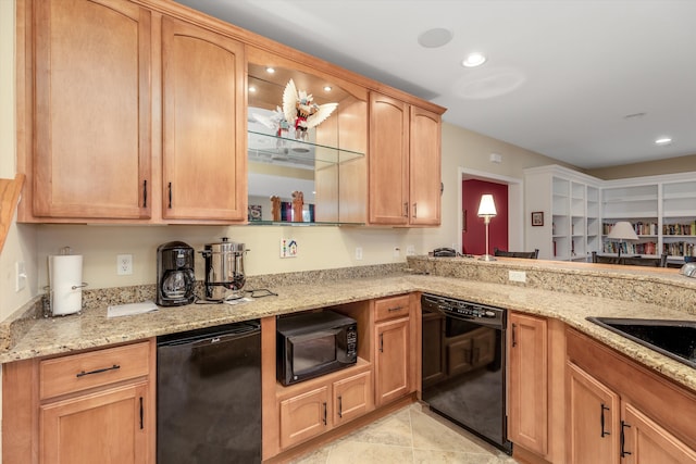 kitchen featuring sink, light brown cabinets, light stone counters, light tile patterned floors, and black appliances