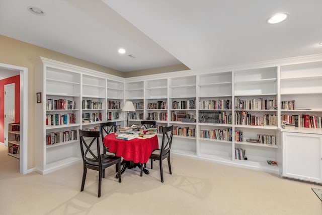 dining area featuring light carpet