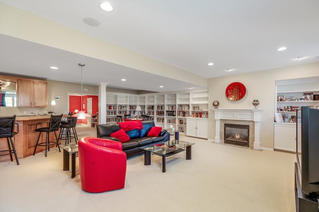 living room featuring light colored carpet, built in features, and a premium fireplace