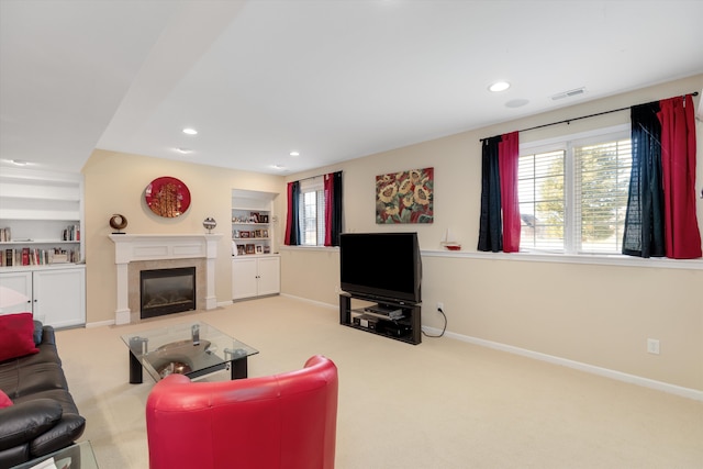 carpeted living room featuring built in features