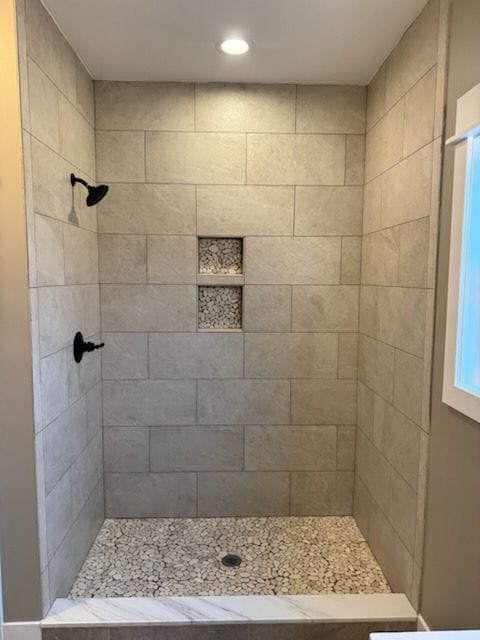 bathroom with a tile shower