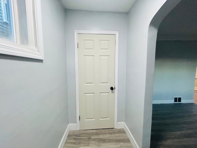 corridor featuring wood-type flooring